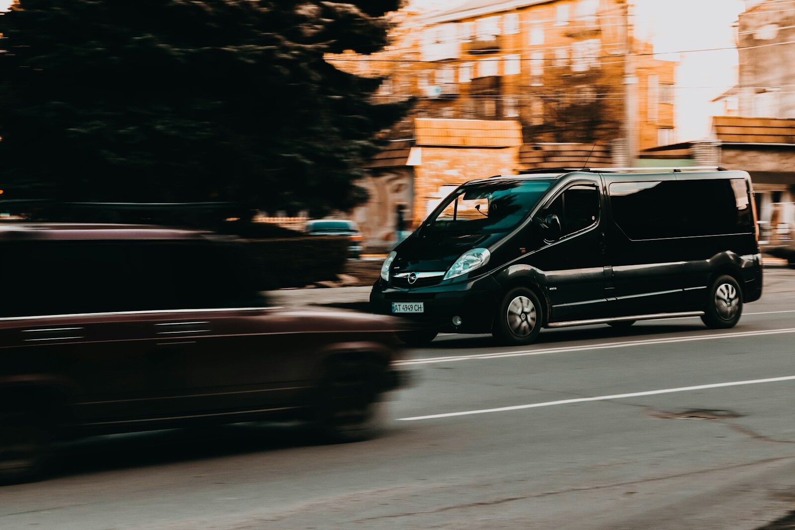 a black car driving on a road